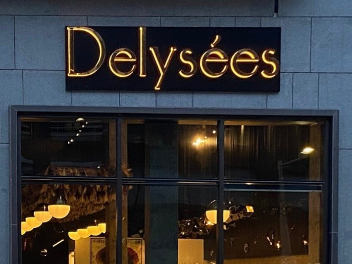 Illuminated backlit channel letters storefront sign glowing at night in Ottawa